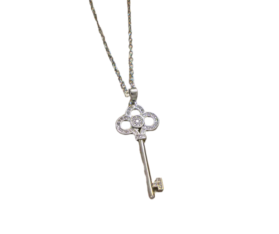 Elegant skeleton key pendant with cubic zirconia accents, symbolizing self-expression and the power to unlock lifeās beauty.