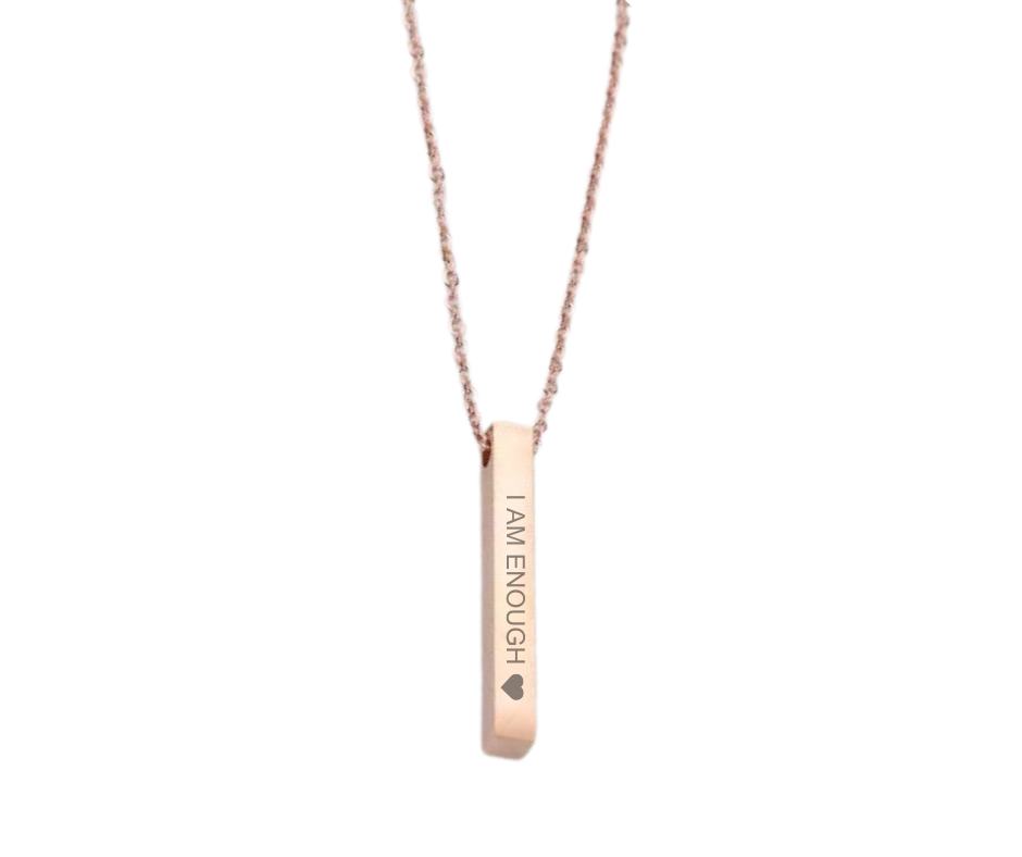 Sleek bar pendant necklace engraved with affirmations and a heart, symbolizing strength, value, and self-love. 5 colors available: Gold, Silver, Rose Gold, Iridescent, Black.