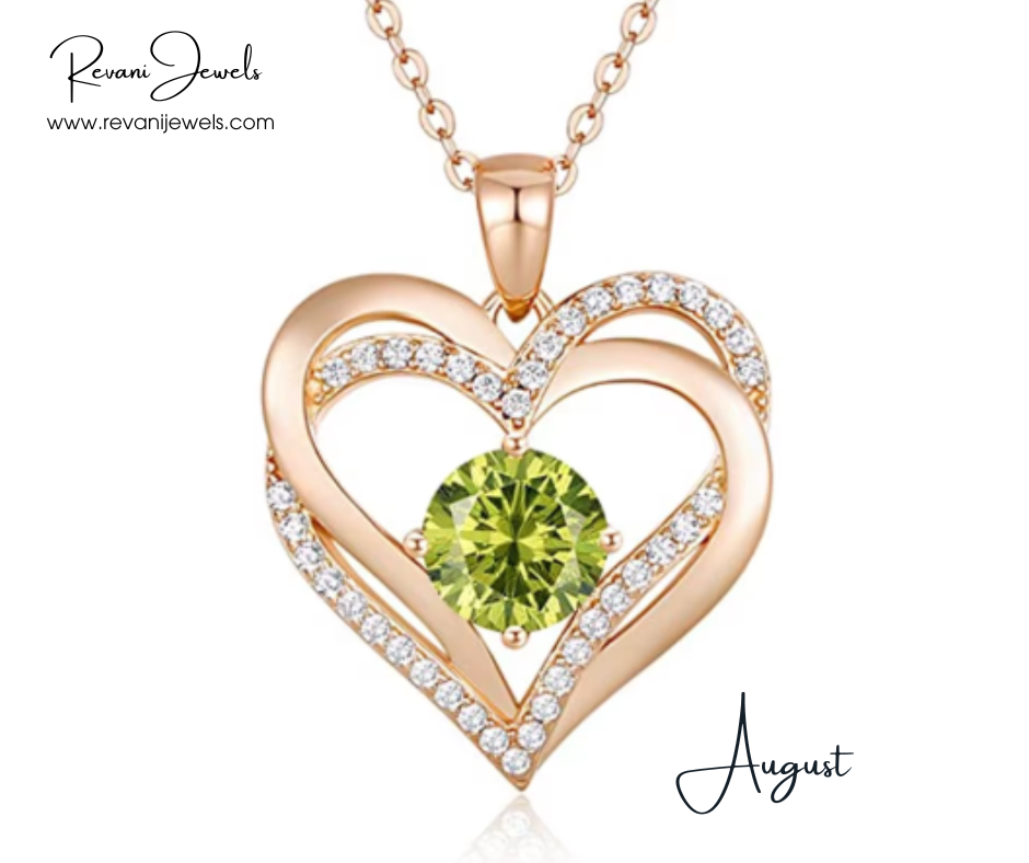 Heart-shaped gold pendant with a green gemstone and diamonds, branded 'Revani Jewels'.