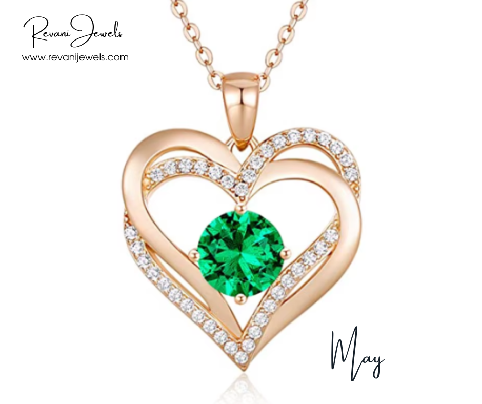 Heart-shaped gold pendant with a green gemstone and diamonds, branded 'Revani Jewels'.