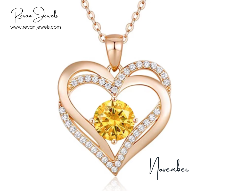 Rose gold heart-shaped pendant with yellow gemstone and diamonds, branded 'Revani Jewels', on a white background.