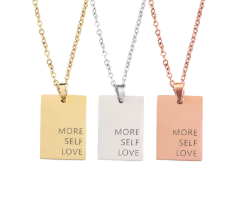 Gold, silver, or rose gold rectangular pendant engraved with "More Self Love," on an 18-inch chain. A daily reminder of self-compassion.