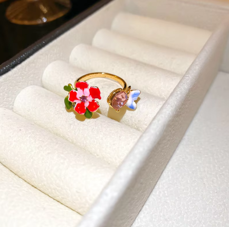 Floral jewelry set with vibrant hues, faux pearls, and CZ accents. Gold-plated vintage charm inspired by poppies and lyrical prose.