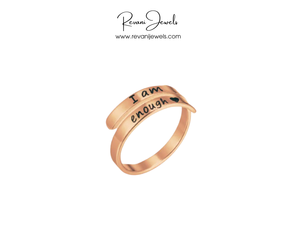 Rose gold ring with 'I am enough' engraving on a white background, branded as Revani Jewels.