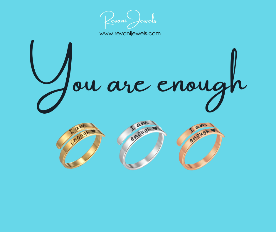 Three rings with 'I am enough' engraving on a blue background with 'Revan Jewels' branding.