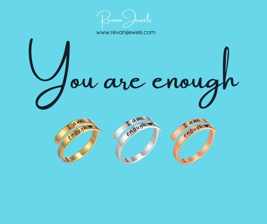 Three rings with 'I am enough' engraving on a blue background with 'Revan Jewels' branding.