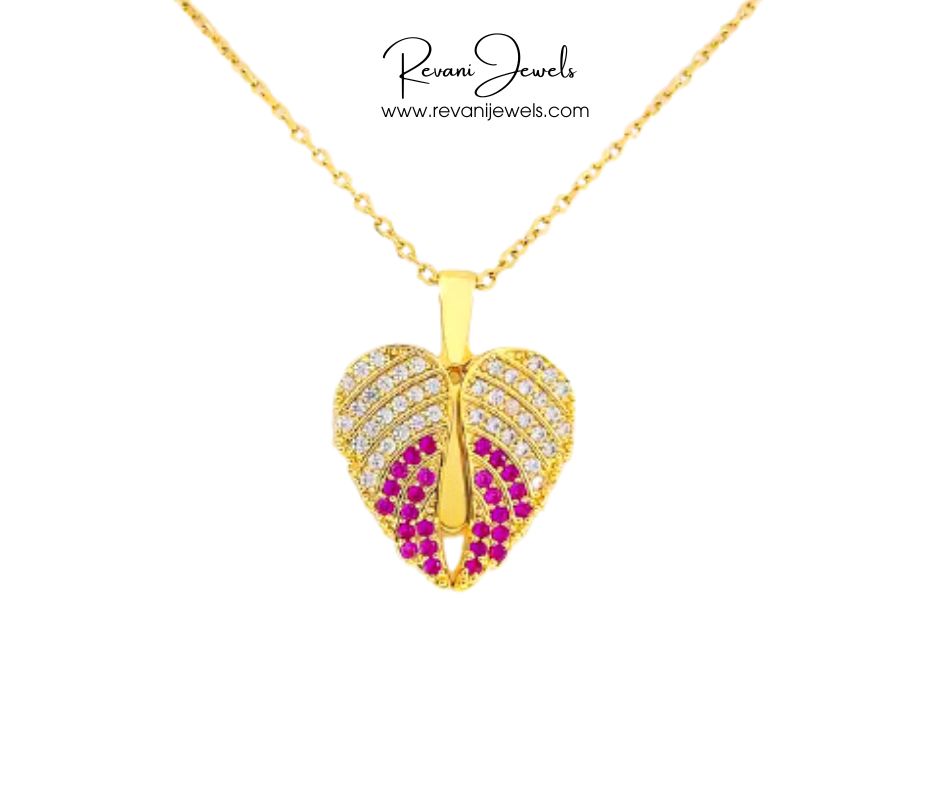 Gold heart-shaped pendant with red and white stones on a white background, branded 'Revani Jewels'.