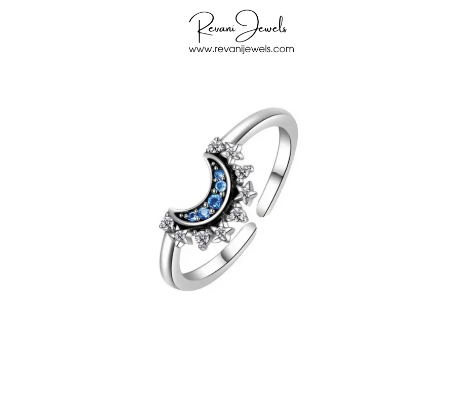Silver ring with blue gemstone and diamond accents on a white background, branded 'Revani Jewels'.