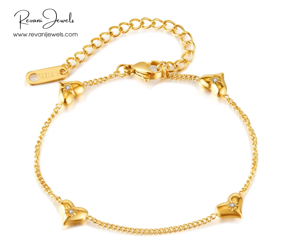 Gold bracelet with heart-shaped charms on a white background, branded 'Revani Jewels'.