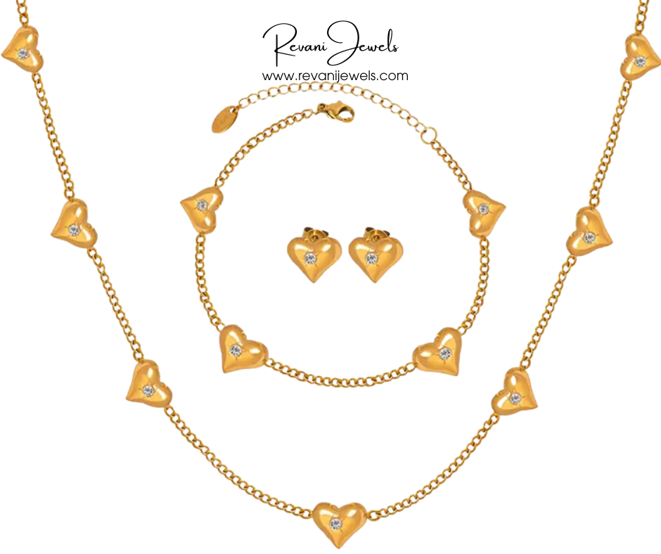 Gold heart-shaped jewelry set with necklace, bracelet, and earrings on a white background, branded 'Revani Jewels'.