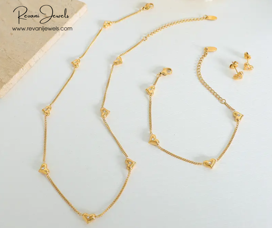 Gold necklace and bracelet set on a light background with Revani Jewels branding.