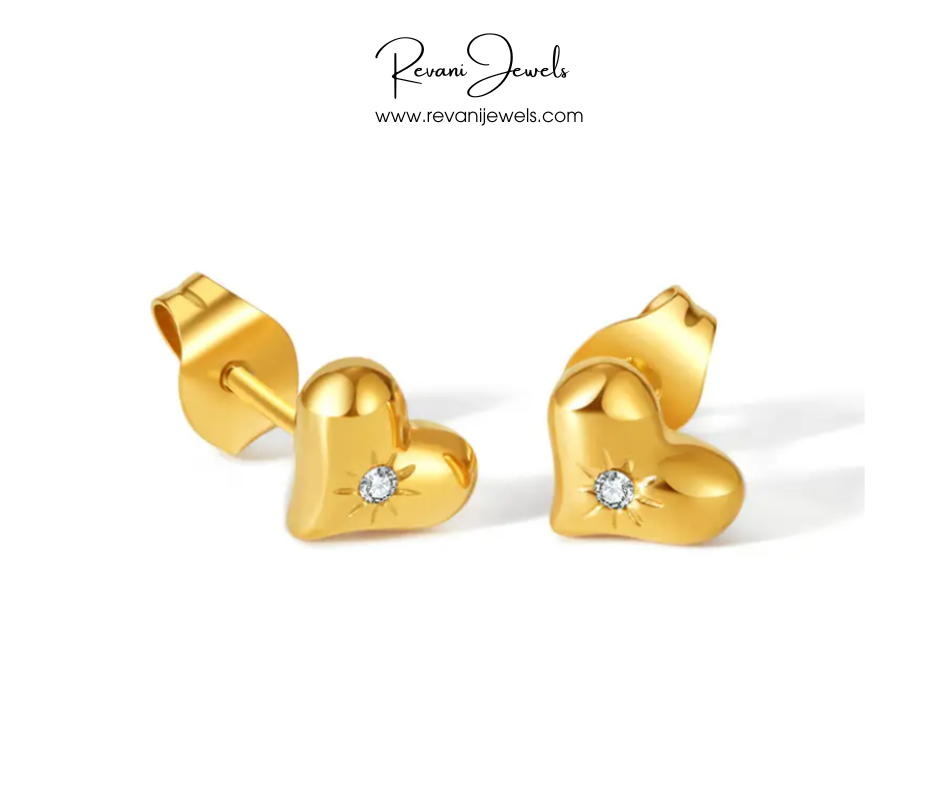 Gold heart-shaped earrings with diamonds on a white background, branded as Revani Jewels.