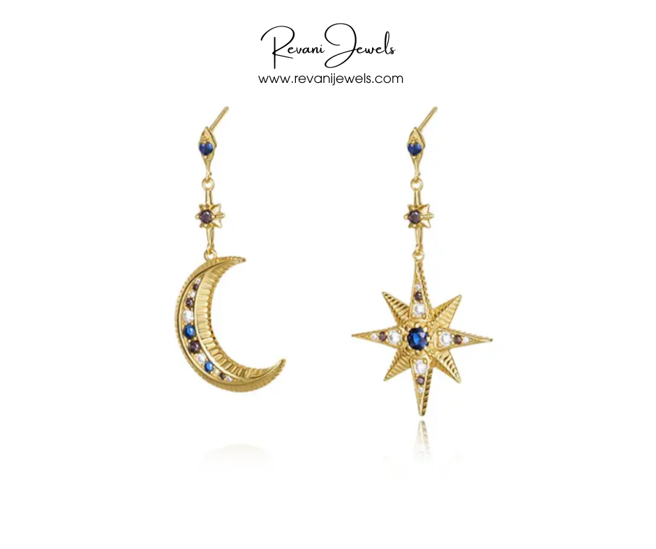 Gold earrings shaped like a moon and star with blue stones on a white background, branded 'Revani Jewels'.