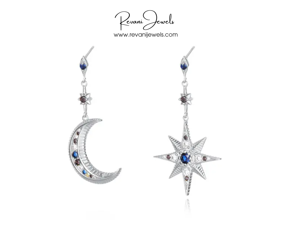 Pair of silver earrings with star and crescent moon designs on a white background, branded 'Revani Jewels'.