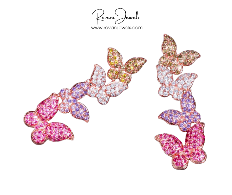 Butterfly-shaped earrings with pink and gold colors on a white background, branded as Revani Jewels.