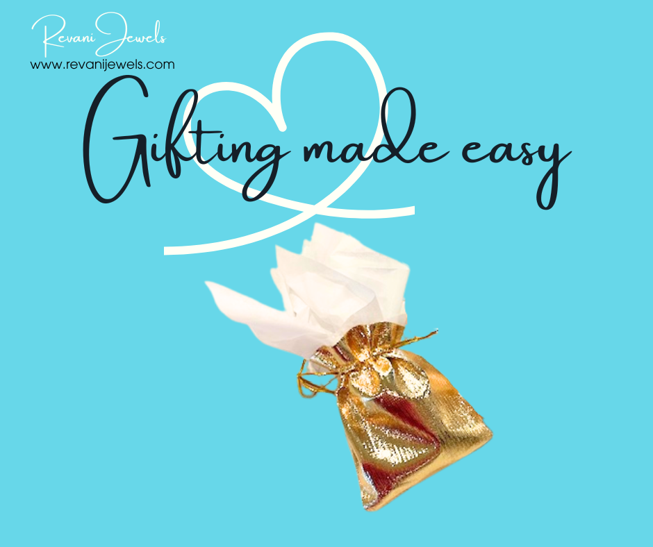 Gold gift bag with white ribbon on a blue background with 'Gifting made easy' text and Revan Jewels logo.