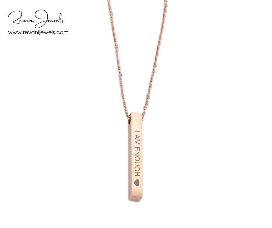 Rose gold necklace with 'I AM ENOUGH' pendant on a white background, branded 'Revani Jewels'.