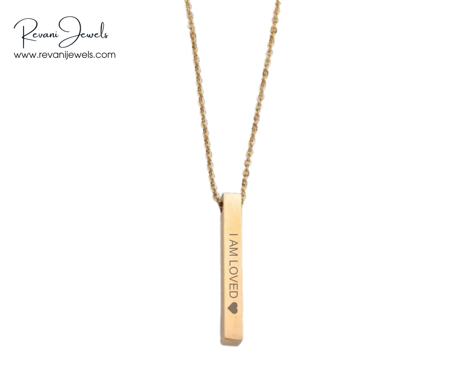 Gold necklace with 'I AM LOVED' pendant on a white background, branded as Revani Jewels.