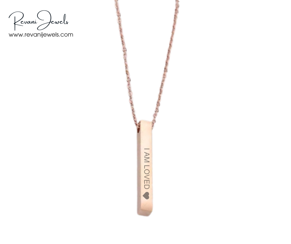 Rose gold necklace with 'I AM LOVED' pendant on a white background, branded as Revani Jewels.
