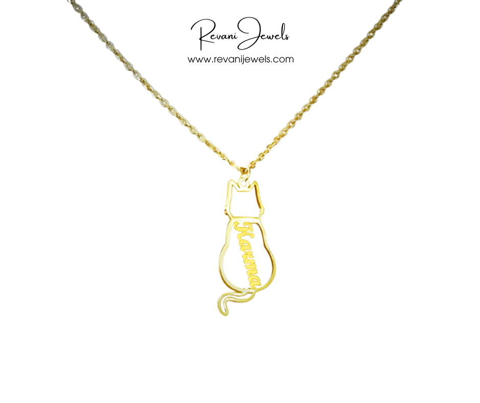 Gold cat-shaped pendant necklace on a white background with 'Revani Jewels' branding.