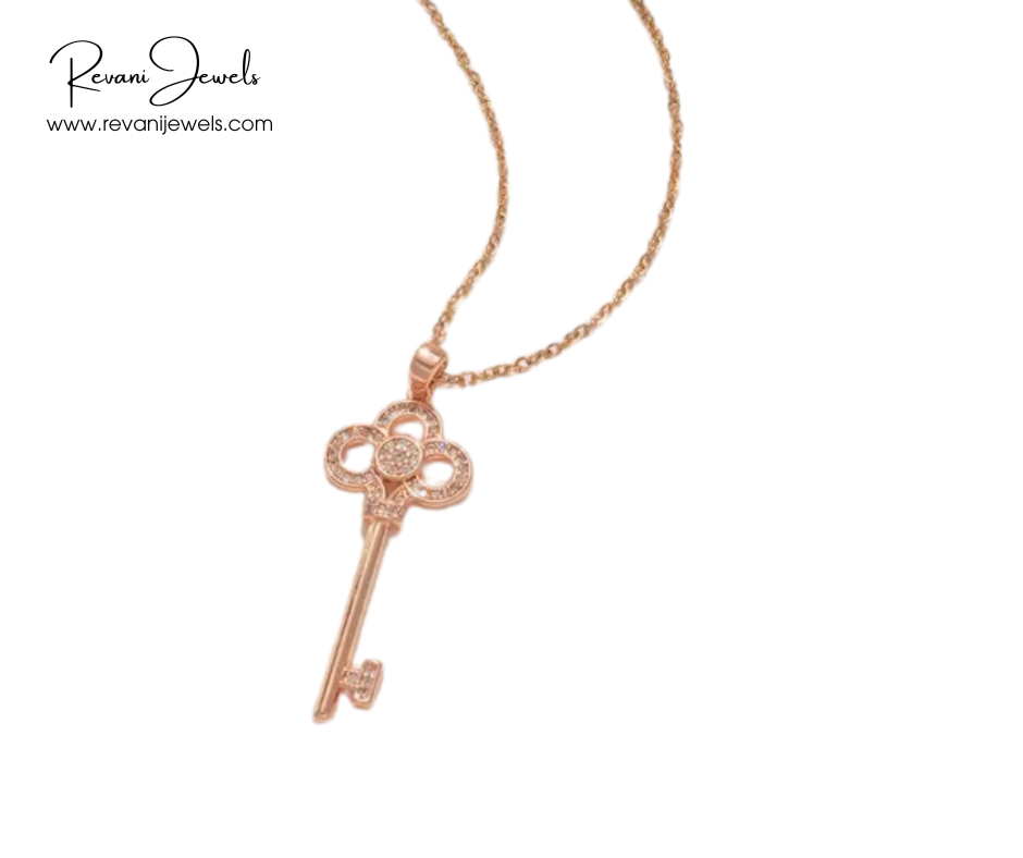 Rose gold key-shaped pendant on a chain with Revani Jewels branding.