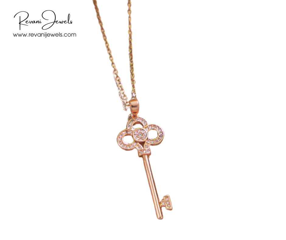 Rose gold key-shaped pendant necklace on a white background with Revani Jewels branding.