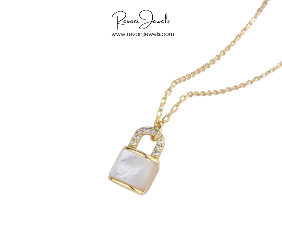 Gold necklace with a lock-shaped pendant featuring a white stone on a white background, branded 'Revani Jewels'.