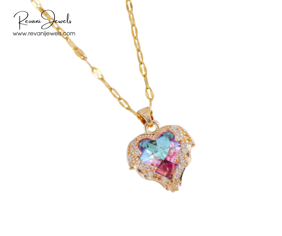 Heart-shaped gemstone necklace with gold chain on a white background, branded 'Revani Jewels'.
