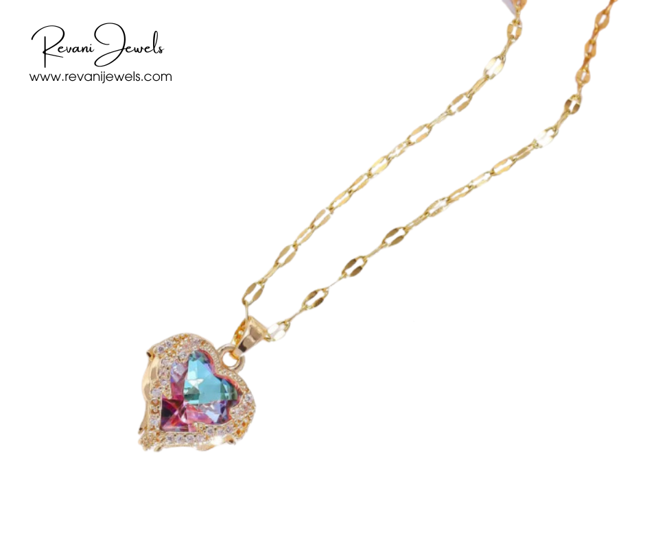 Heart-shaped gemstone necklace with gold chain on a white background, branded 'Revani Jewels'.