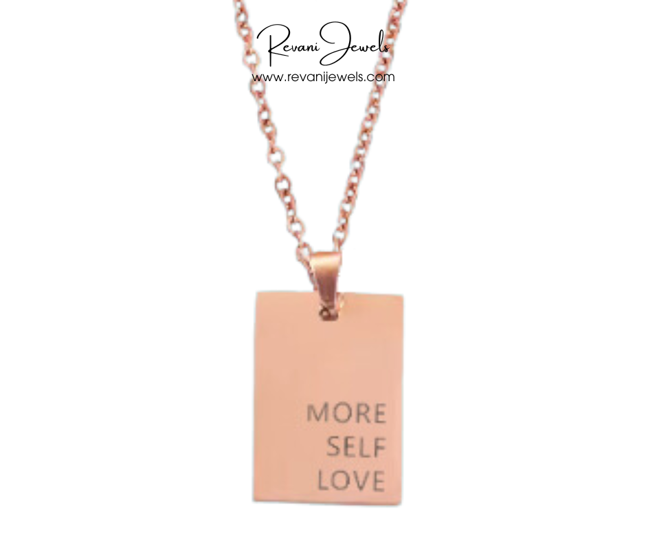Rose gold necklace with a pendant that says 'More Self Love' on a white background, branded as Revani Jewels.