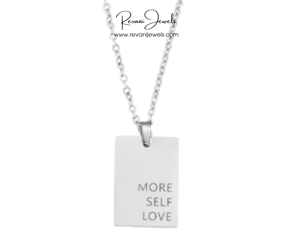 Silver necklace with a pendant that says 'More Self Love' on a white background, branded as Revani Jewels.