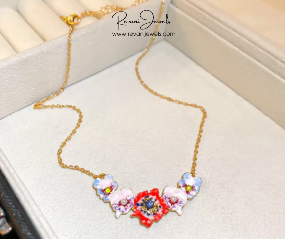 Colorful floral necklace on a white surface with 'Revani Jewels' branding.