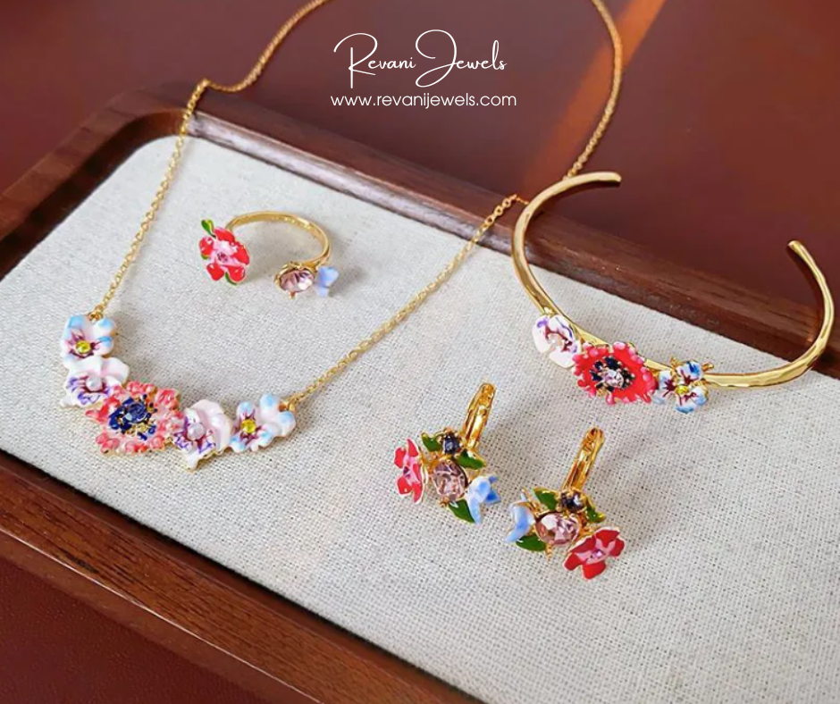 Jewelry set with floral designs on a textured surface, featuring 'Revani Jewels' branding.