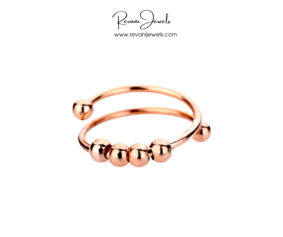 Rose gold ring with spherical beads on a white background, branded as Revani Jewels.