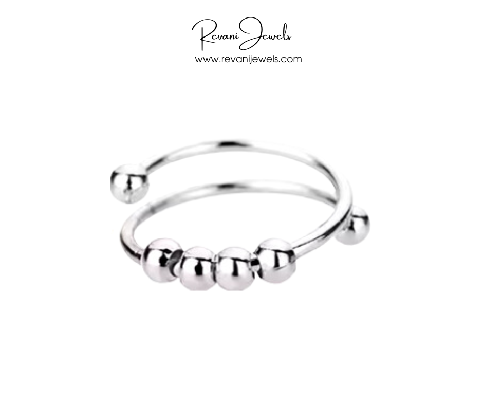 Silver bangle with beads on a white background, branded as Revani Jewels.