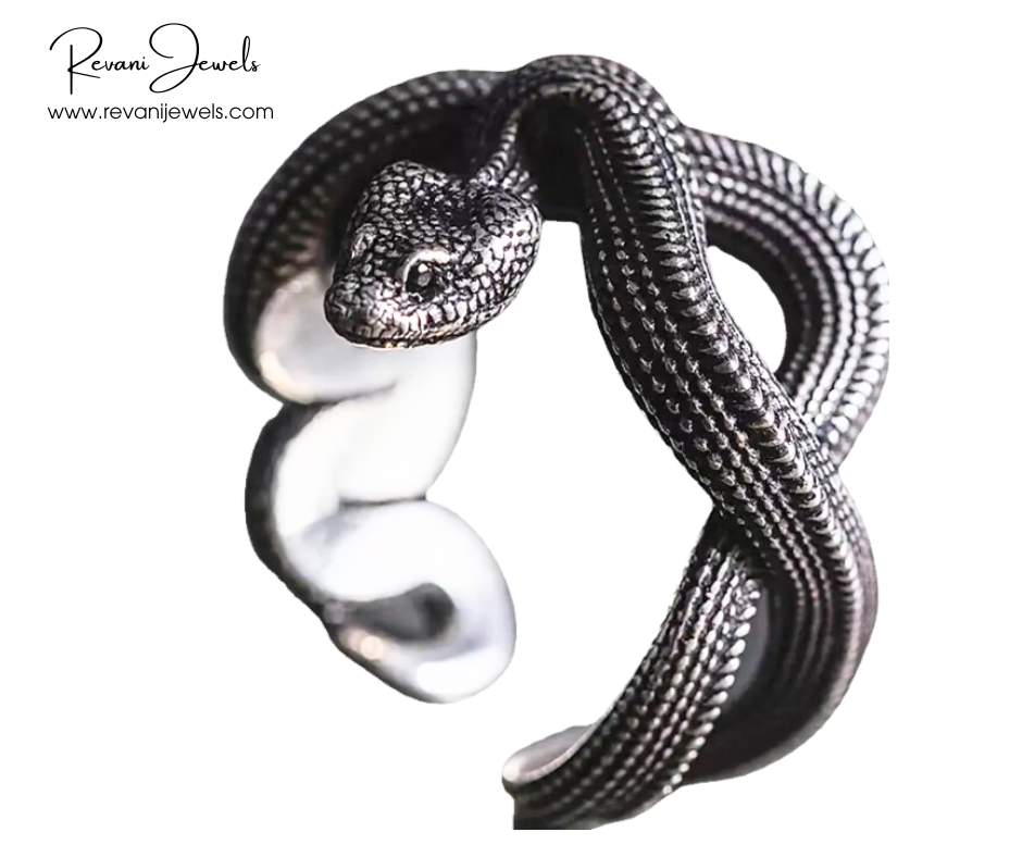Silver snake-shaped cuff bracelet on a white background with 'Revani Jewels' branding.