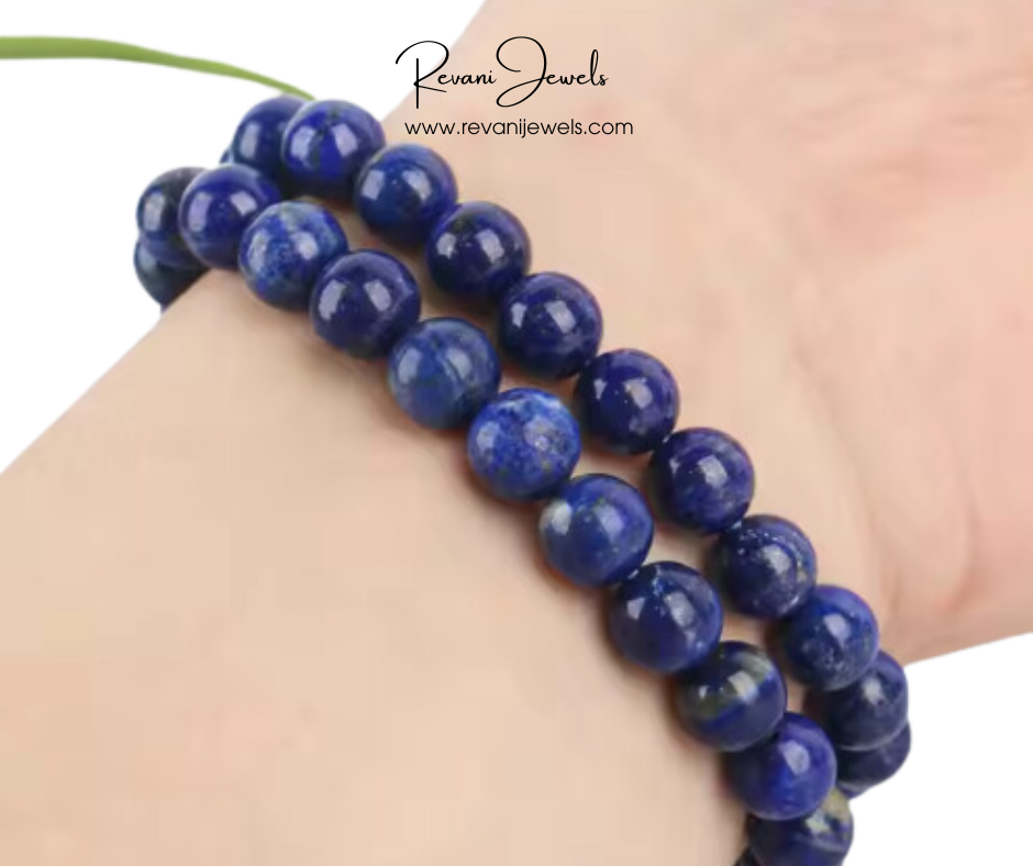 Blue beaded bracelet on a wrist with 'Revani Jewels' branding.