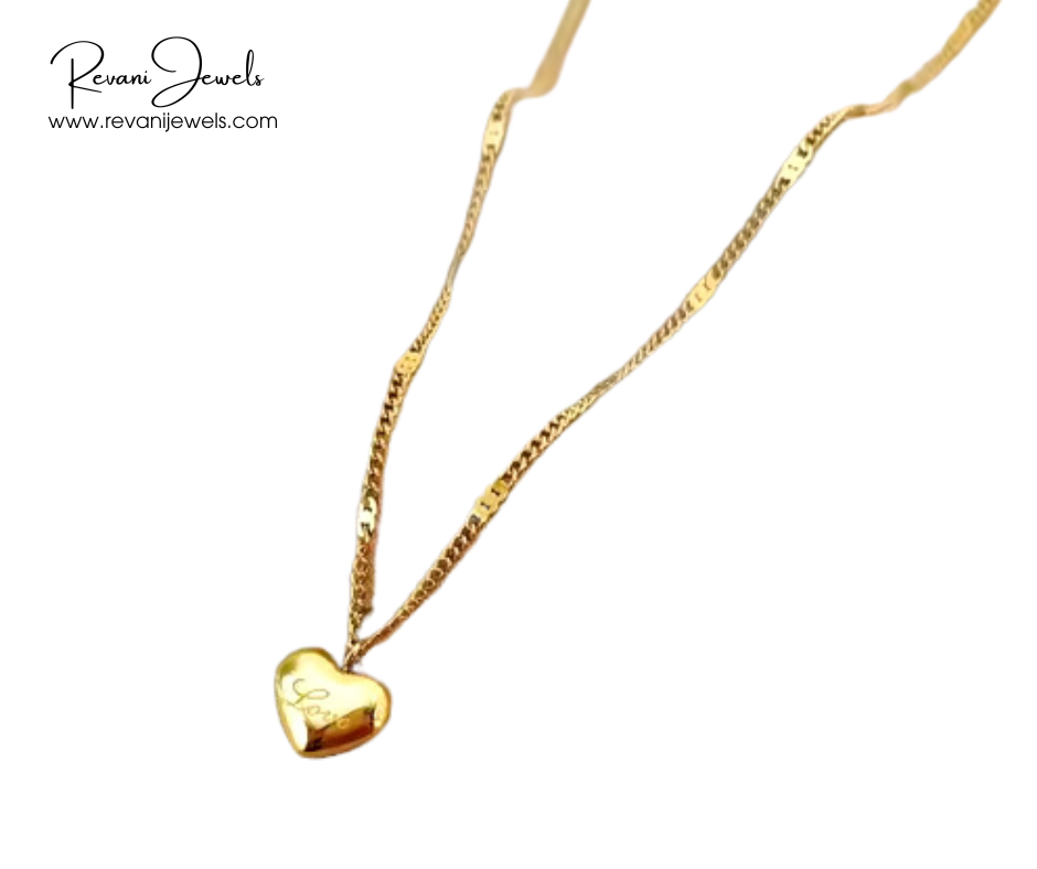 Gold necklace with a heart-shaped pendant on a white background, branded 'Revani Jewels'.