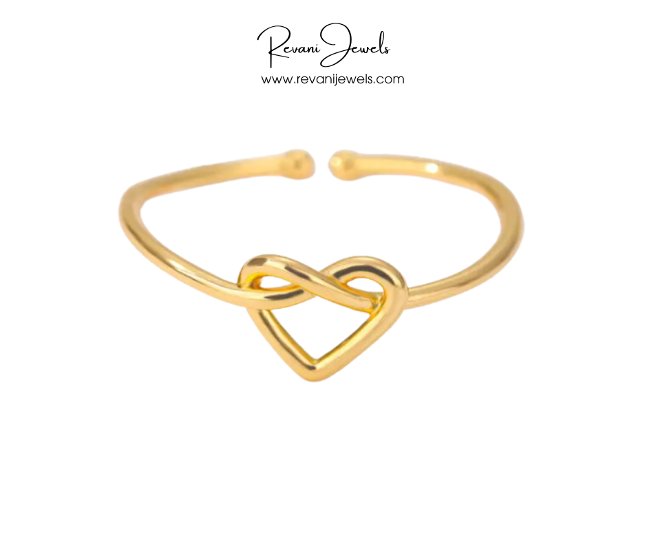 Gold bracelet with a heart and infinity symbol design on a white background, branded 'Revani Jewels'.