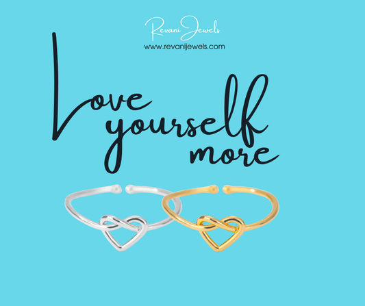 Two open heart-shaped rings, one silver and one gold, on a blue background with 'Love yourself more' text and Revani Jewels branding.