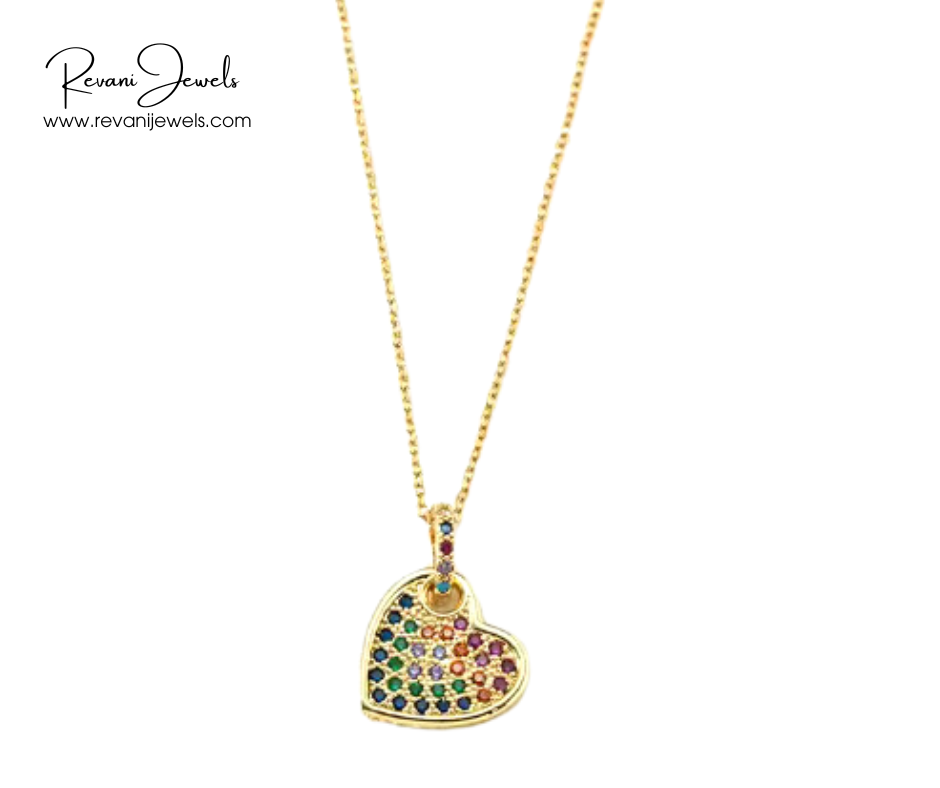 Heart-shaped pendant with colorful stones on a gold chain, branded 'Revan Jewels'.