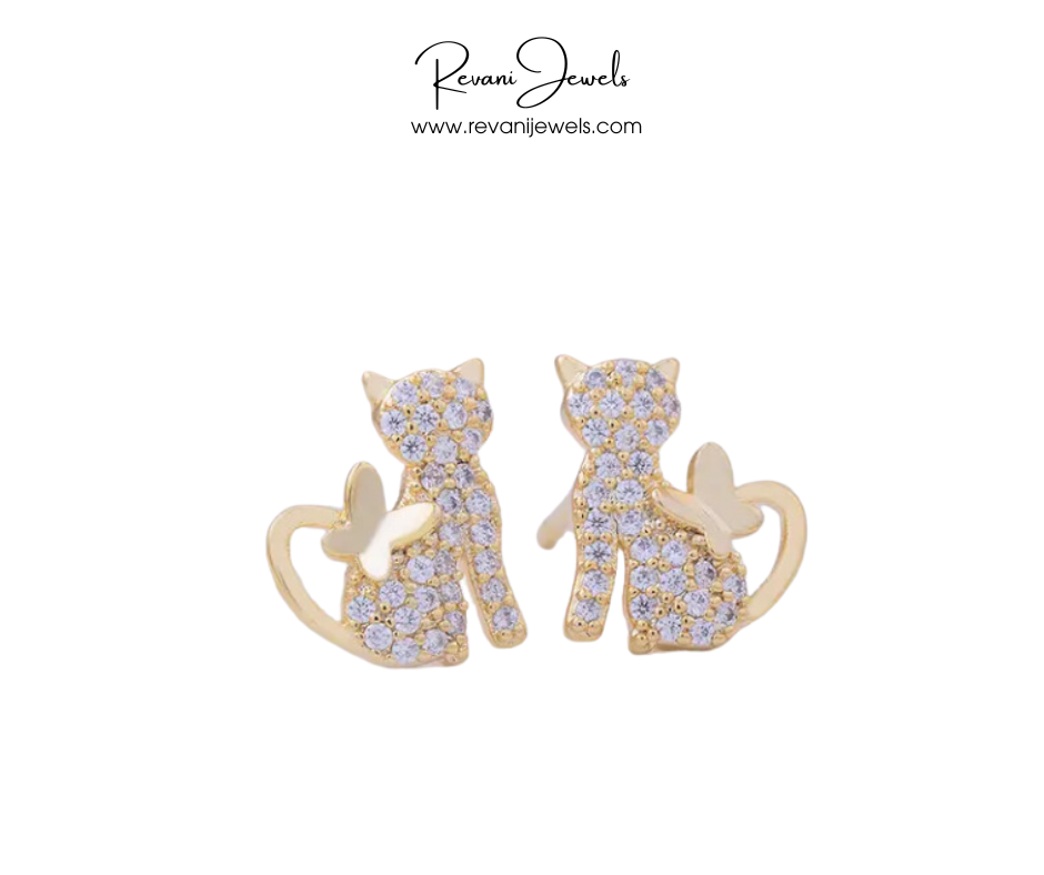 Cat-shaped earrings with gemstones on a white background, branded as Revani Jewels.