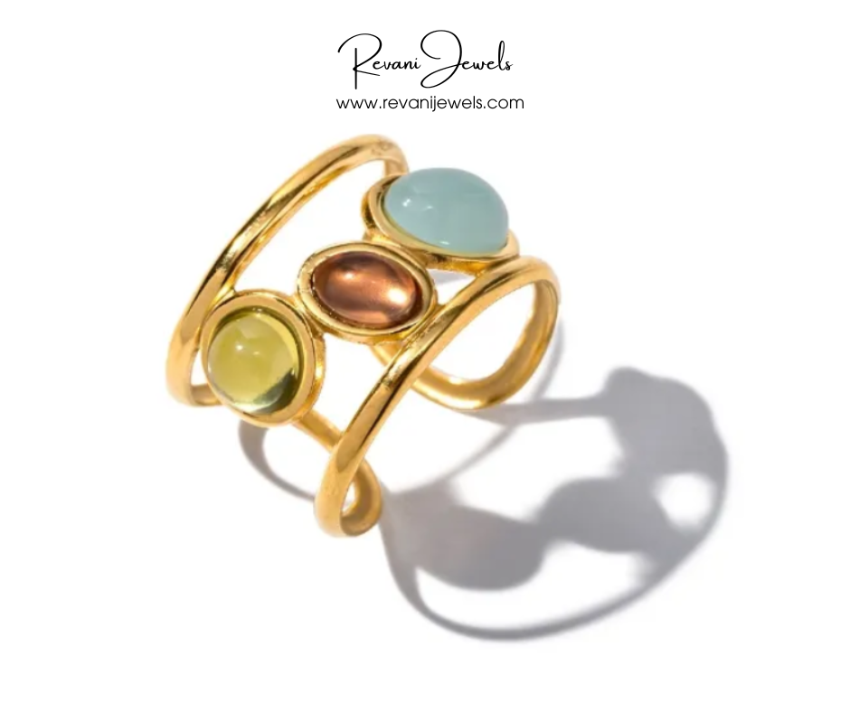 Gold ring with multicolored gemstones on a white background, branded as Revani Jewels.
