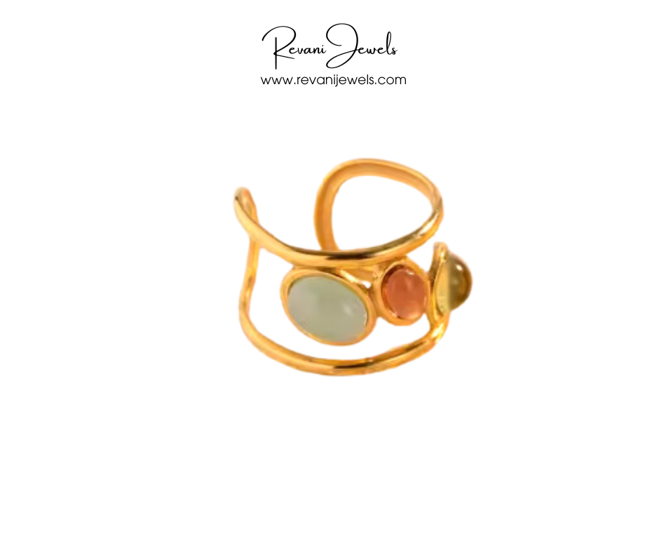 Gold ring with colored stones on a white background, branded as Revani Jewels.